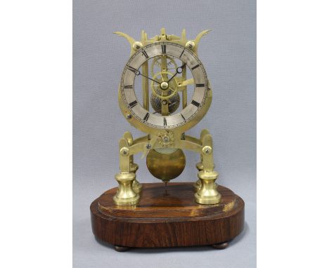 Victorian brass skeleton clock with silvered chapter ring with black Roman numerals, on a rosewood base, 30cm 