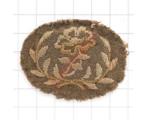 Queen Mary's Army Auxiliary Corps WW1 Forewoman’s rank badge circa 1918. Rose within laurel sprays embroidered on khaki padde