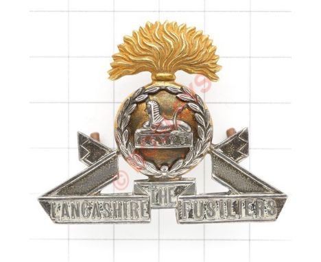 Lancashire Fusiliers Officer’s cap badge Die-cast silver and gilt. Firmin London Loops Toned VGC .