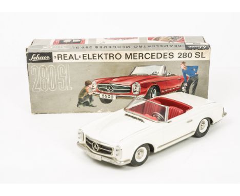 A Schuco 5500 Tinplate Battery Operated Remote Control Mercedes 280SL, white body, red interior, plated trim, with key, tools