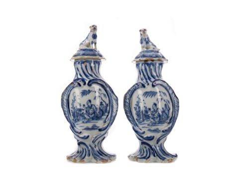 PAIR OF 19TH CENTURY DUTCH DELFTWARE BLUE &amp; WHITE VASES, each of baluster form, the cover with dog finial, hand-painted w