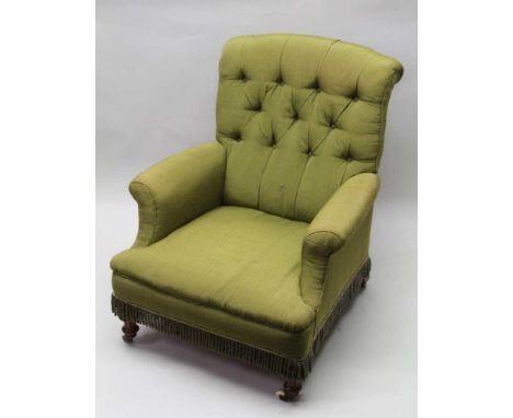 A VICTORIAN DEEP SEATED EASY CHAIR, turned and fluted fore supports on ceramic castors, green fabric upholstered, button back