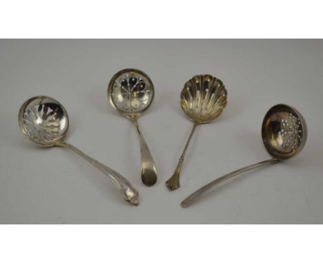 FOUR VARIOUS SILVER SIFTING LADLES, various designs and assay marks, to include the years; 1909, 1910, 1915, 1973, combined w