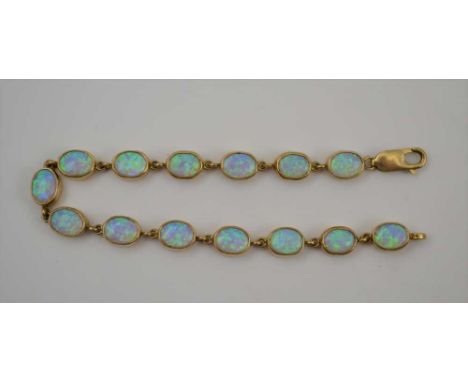 A 9CT GOLD OPAL MOUNTED BRACELET with fourteen oval opal links, length; 19cm (including the clip), weight; 12gCondition repor