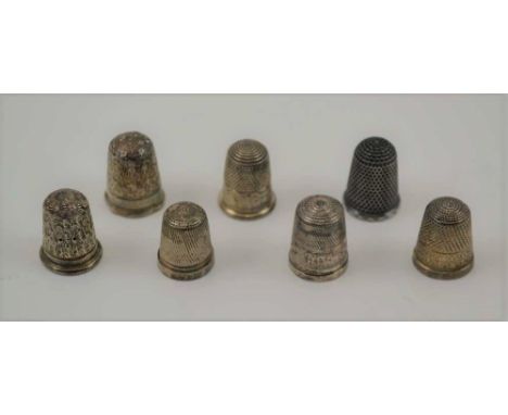 SEVEN HALLMARKED SILVER THIMBLES, of various designs and makers 