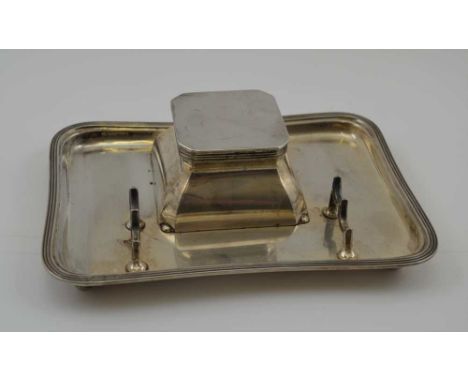 HUKIN &amp; HEATH LTD A SILVER INKSTAND with pen rack, the hinged lid opening to reveal a clear glass liner, the tray raised 