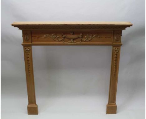 AN ADAM DESIGN PINE FIRE SURROUND, with urn, scrolls and graduated bell husk decoration, mantel shelf, 139.5cm wide Condition