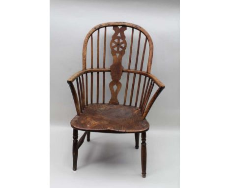 A 19TH CENTURY OPEN ARM WINDSOR CHAIR, pierced wheel back splat, elm seat on turned supports Condition report – Front leg loo