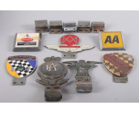 Seven metal and enamel car badges, including "Sunbeam Talbot Owners Club" and "Aston Martin Owners Club" 