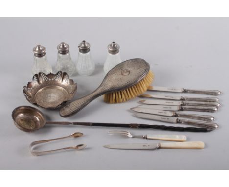 A silver dish with pierced decoration, a silver-backed hairbrush, a pair of cut glass and silver mounted pepper shakers, a pa