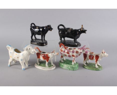 Six 19th century and later model cow creamers, including a German cow creamer with floral decoration, 6" high (damages) 