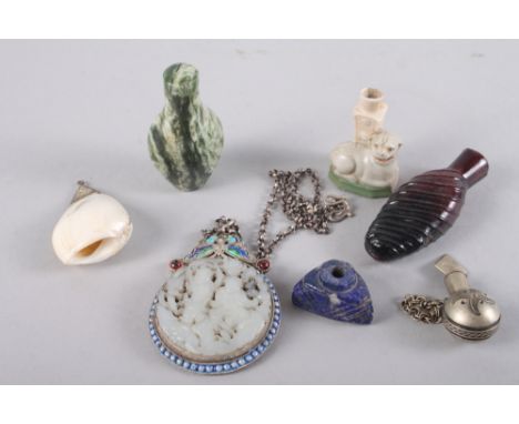 A Chinese pale celadon roundel, decorated figures, in a white metal and enamel pendant frame, three snuff bottles, various, a