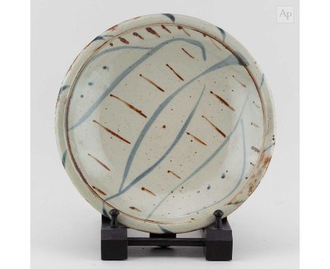 † MICHAEL CARDEW (1901-1983) for Wenford Bridge Pottery; a stoneware plate with Vume lily decoration, impressed MC and potter