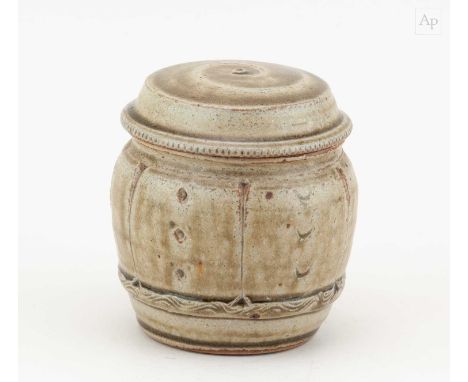 † MIKE DODD (born 1943); a stoneware caddy covered in green ash glaze with impressed and incised decoration, height 11.5cm,Co