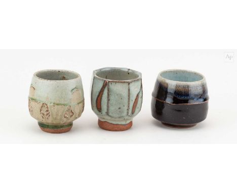 † PHIL ROGERS (1951-2020); a trio of stoneware yunomi covered in different glazes, impressed PR marks, tallest 9cm (3).Condit
