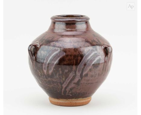 † PHIL ROGERS (1951-2020); a lugged angular stoneware jar covered in tenmoku breaking to kaki glaze with wax resist decoratio