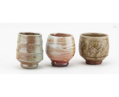 † PHIL ROGERS (1951-2020); a trio of stoneware yunomi covered in different glazes, impressed PR marks, tallest 10.5cm (3).Con