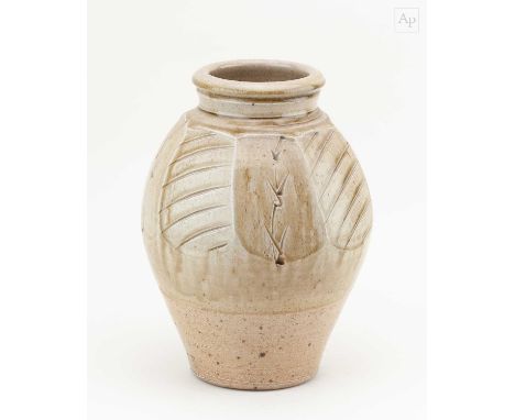 † PHIL ROGERS (1951-2020); a faceted salt glazed bottle partially covered in green ash glaze with incised decoration, impress