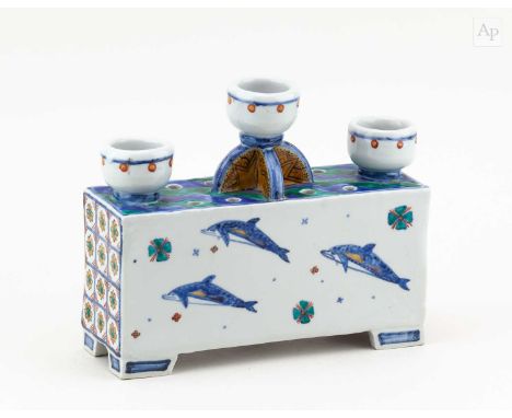 † RUSSELL COATES (born 1949); a rectangular porcelain candleholder covered in off white glaze with Japanese style enamel deco