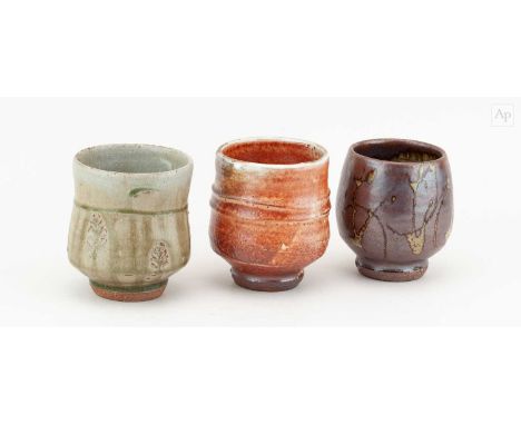† PHIL ROGERS (1951-2020); a trio of stoneware yunomi covered in different glazes, impressed PR marks, tallest 10cm (3).Condi