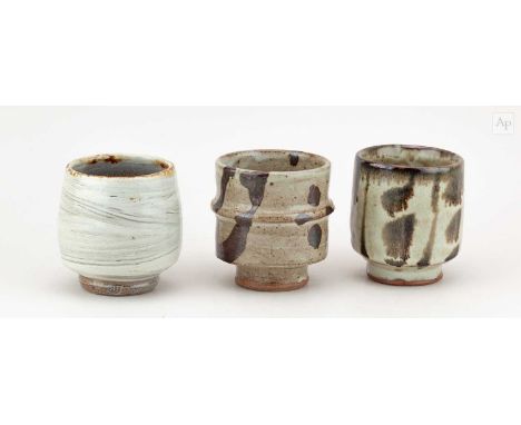 † PHIL ROGERS (1951-2020); a trio of stoneware yunomi covered in different glazes, impressed PR marks, tallest 9.5cm (3).Cond