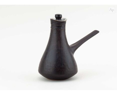 † LUCIE RIE (1902-1995); a stoneware coffee pot covered in manganese glaze with sgraffito decoration, impressed LR mark, made
