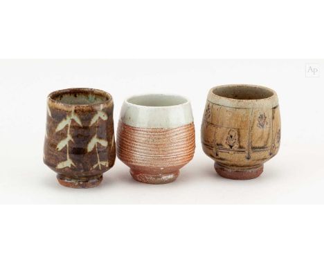 † PHIL ROGERS (1951-2020); a trio of stoneware yunomi covered in different glazes, impressed PR marks, tallest 10cm (3).Condi