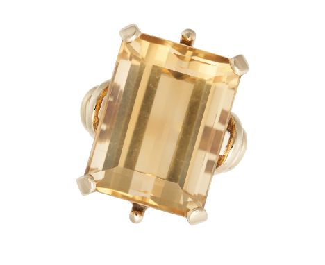 A CITRINE COCKTAIL RING in 18ct yellow gold, set with a rectangular step cut citrine of approximately 22.66 carats, stamped 1