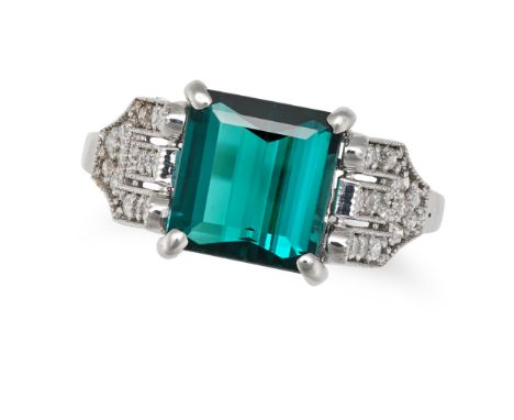 A GREEN TOURMALINE AND DIAMOND DRESS RING in 18ct white gold, set with an octagonal step cut green tourmaline, the stylised s