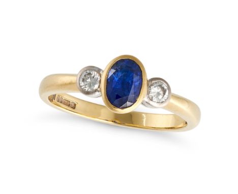 A SAPPHIRE AND DIAMOND THREE STONE RING in 18ct yellow gold, set with an oval cut sapphire accented on each side by a round b