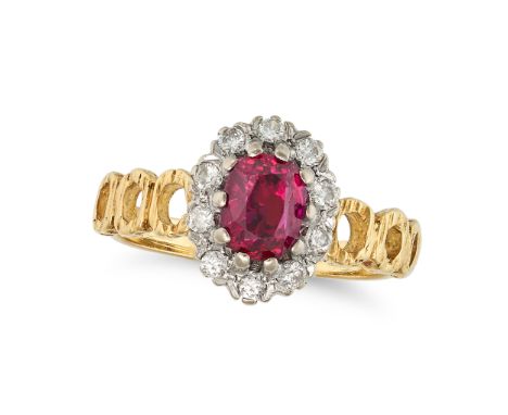 A RUBY AND DIAMOND CLUSTER RING in 18ct yellow gold, set with an oval cut ruby in a cluster of round brilliant cut diamonds, 