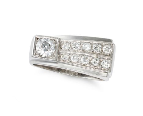 A DIAMOND DRESS RING in white gold, set with an old European cut diamond of approximately 0.24 carats, accented by two rows o