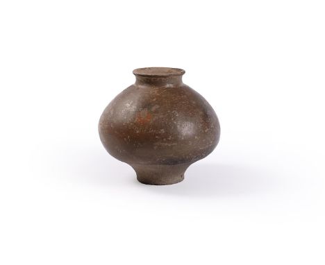 A Chinese pottery Jar, perhaps Han or Six Dynasties or earlier, the ovoid body with a light brown glaze and the unglazed lowe