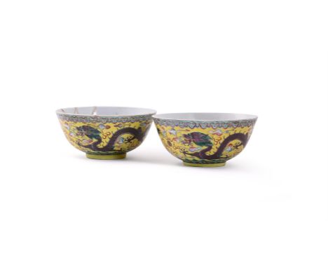 A pair of Chinese yellow-ground Famille Rose 'Dragon' bowls, with Kangxi marks but Guangxu period, both painted with a pair o