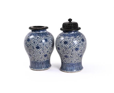 A pair of Chinese blue and white vases, Qing Dynasty, late 18th century, painted with scrolling flower foliage with a ruyi he