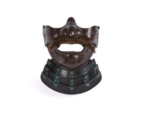 A Japanese Russet Iron Mempo, of ressei form  with fierce expression, detachable nose, wide mouth with gilt teeth, with moust