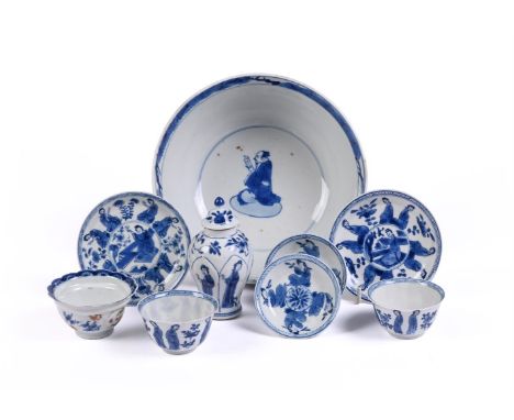 A pair of Chinese blue and white tea bowls and saucers, Kangxi, painted with pairs of ladies, one with qin character to base,