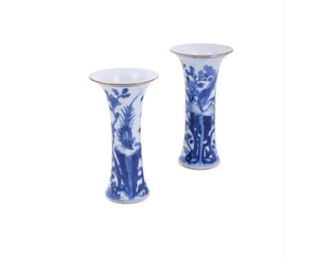 A pair of Chinese blue and white vases, Kangxi, decorated with a bird of paradise perched on pierced rockwork amongst floweri