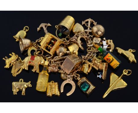 Gold charm bracelet with novelty charms. including an Irish harp, plane, car, lantern and loose charms. mainly 9ct gold 
