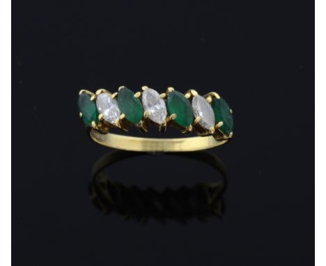 REVISED ESTIMATE  Emerald and diamond set dress ring. set with seven marquise form stones, in 18ct gold 