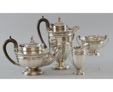 George V silver four piece tea service, comprising teapot, hot-water jug, cream jug and sugar bowl, with gadrooned rims on ro