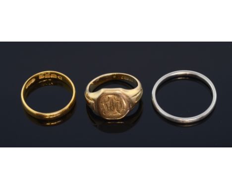 Platinum wedding band and gold rings. 22ct yellow gold wedding band and a gold signet ring 