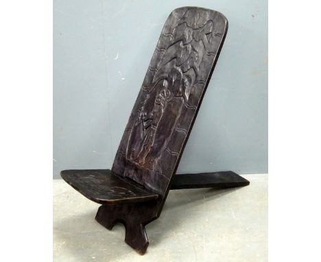 Carved African chair of X-frame proportion, carved with a Native figure with an Axe