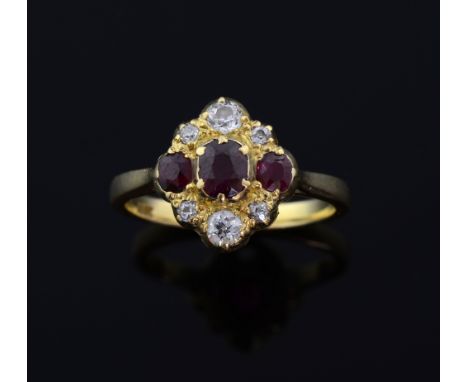 1920's ruby and diamond cluster ring. set with three oval-cut rubies to a surround of old cut diamonds mounted in yellow meta