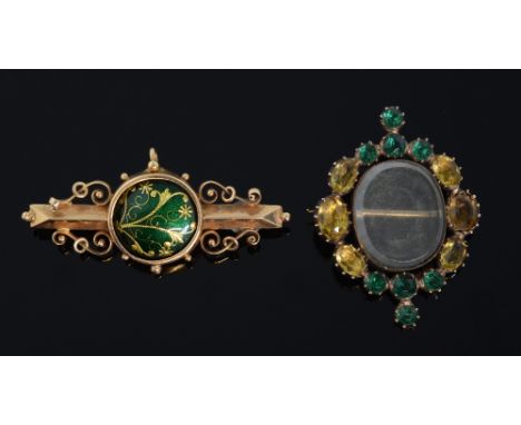  Two Victorian brooches. citrine and paste mourning brooch and an enamel and gold bar brooch 