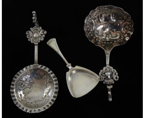 Two Edwardian silver cream spoons import marks with embossed wildlife scenes and a Dutch silver caddy spoon