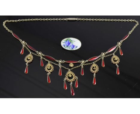 Scandinavian jewellery. brooch of gilt metal and red enamel and a David Andersen enamel brooch. 