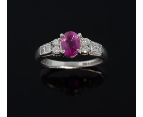 Ruby and diamond ring, with a central  oval cut ruby weighing approximately 1.12cts mounted in platinum 