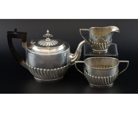 Edward VII silver three piece tea service, comprising teapot, cream jug and sugar bowl with half-reeded bodies, by Walker & H