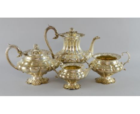 William IV silver four piece tea service, comprising teapot, hot-water jug, cream jug and sugar bowl, of lobed form on foliat